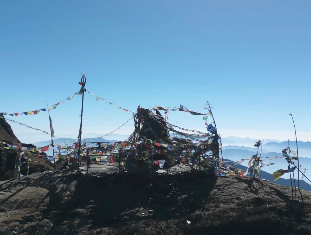 A mountaintop shrine draped in Buddhist prayer flags at Shingla, Ruby Valley, Nepal.
